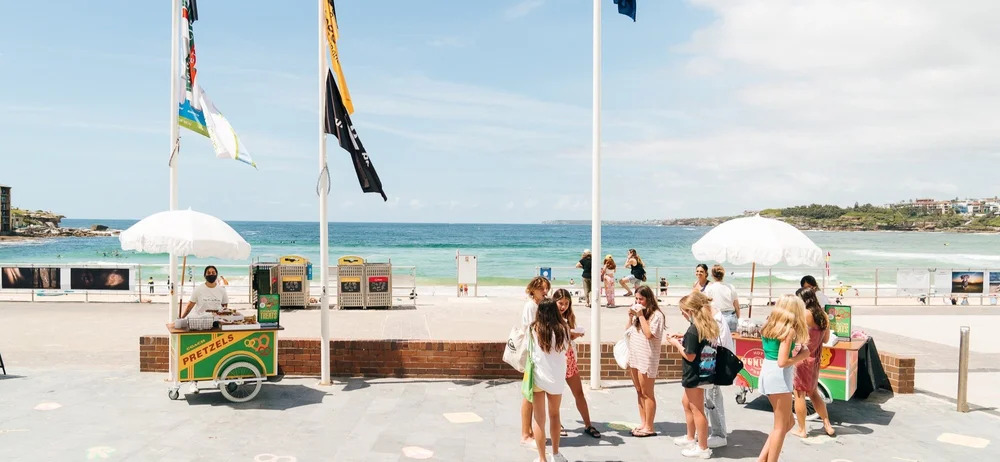 People enjoying an event on a beach